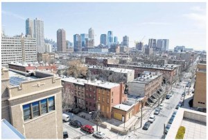 The rooftop terrace at Hamilton Square Condominiums in Jersey City is a popular amenity, according to the building's developers, Eric and Paul Silverman. The common area is accessible to all building residents and includes a small kitchen, a shaded seating area and several outdoor lounge chairs. (Molly J. Smith Journal Photo)