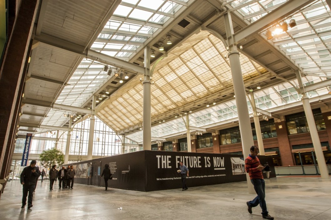 People walk under the 40-foot atrium at the Harborside complex in Jersey City. PHOTO: PETER J. SMITH FOR THE WALL STREET JOURNAL